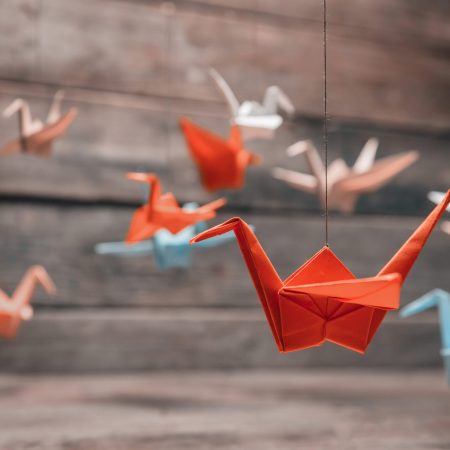 Colorful,Many,Origami,Paper,Cranes,On,Wooden,Background